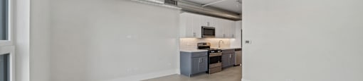 A room with a kitchenette and a window.