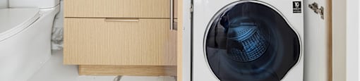 A washing machine is in a cabinet in a kitchen.