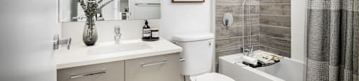 A bathroom with a toilet, sink, and bathtub.