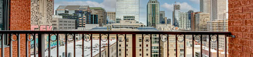 a balcony with a view of the skyline of a city
