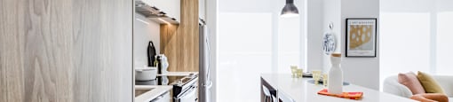 a kitchen with wooden cabinets and a white counter top