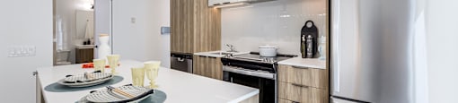 A modern kitchen with a dining table and chairs.