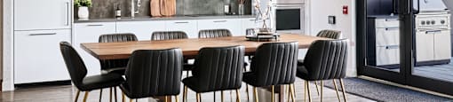 A modern kitchen with a dining table and chairs.