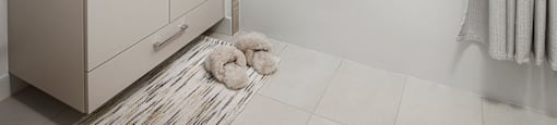 A white bathroom with a shower and a vanity.