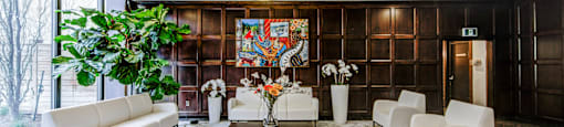 A living room with a large rug and a painting on the wall.