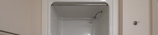 a small shower in a bathroom with a shower curtain
