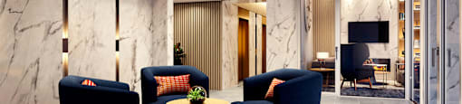 A modern lobby with blue sofa and a wooden coffee table at Chronicle.