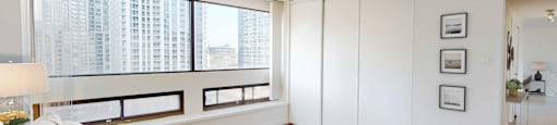 a bedroom with a large bed next to a window