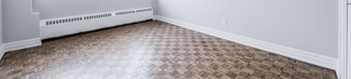 A room with a window and a tiled floor.