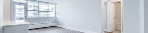 A room with a brown floor and white walls.
