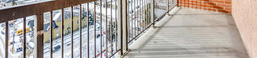 A balcony with a view of a snowy landscape.