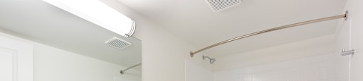 A white bathroom with a toilet, sink, and bathtub.
