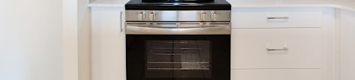 A modern kitchen with a black stove top oven and a microwave above it.