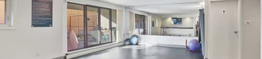 A spacious room with a black floor and white walls.