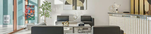 A modern office space with a glass wall and a desk with two chairs.