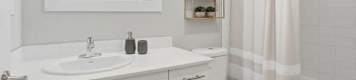 A bathroom with a white sink and toilet.