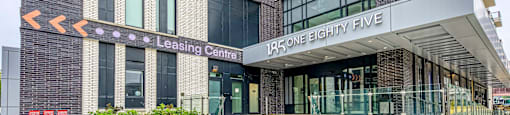 The front of a building with a leasing center entrance.
