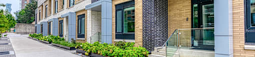 A Leasing Centre building with a brick facade and a glass entrance.