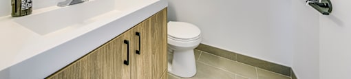 A bathroom with a white toilet and a white sink.