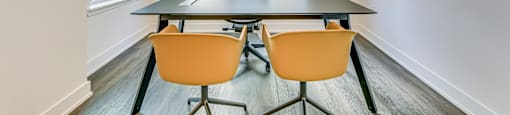 A conference room with a table and chairs.