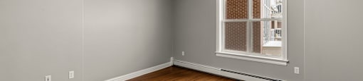 A room with wooden floors and a window.
