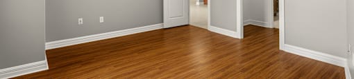 A room with wooden floors and white walls.
