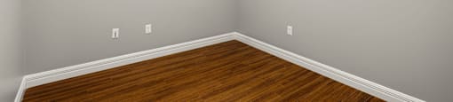 A room with a wooden floor and white walls.