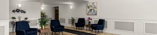 A room with a chandelier, a painting, and a row of chairs.