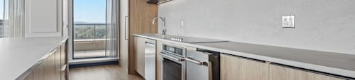 a kitchen with wooden cabinets and white appliances and a sliding glass door