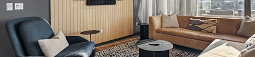 a living room with a couch and a chair and a television