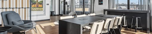 a conference room with a long table and chairs and a large window