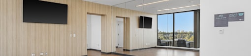 a large room with wood flooring and a large window