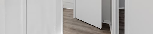 A white door is open to a hallway.