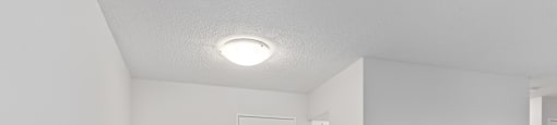 A room with a white door and a white wall.