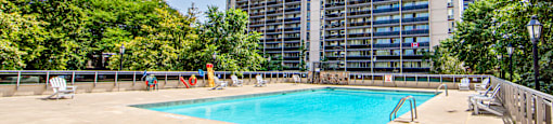 A large building with a pool in front of it.