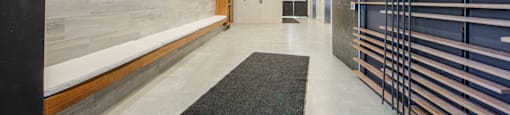 A hallway with a black and white rug in the middle.