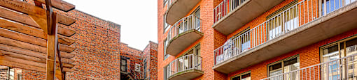 A red brick building with a wooden balcony.