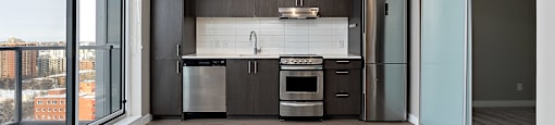 A modern kitchen with a large island and stainless steel appliances.