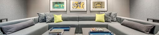 A modern living room with grey couches and a coffee table.