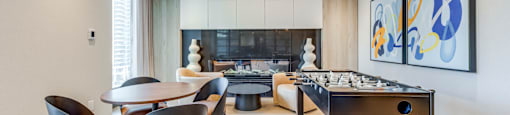 A modern dining room with a pool table and a fireplace.