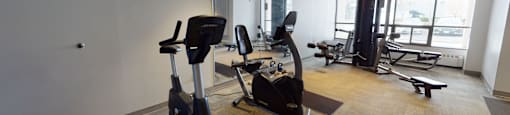 a workout room with exercise equipment in a building