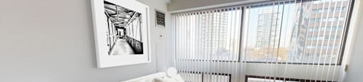 a bedroom with a large bed and a large window