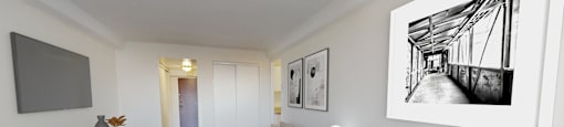 a living room with a large white couch and a tv