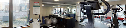 Modern fitness room with various workout equipment