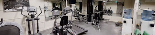 A gym with a variety of exercise equipment.