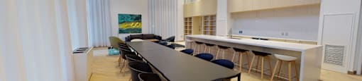 A conference room with a long table and chairs.