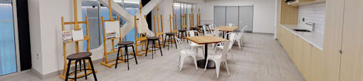 A room with a long table and chairs.
