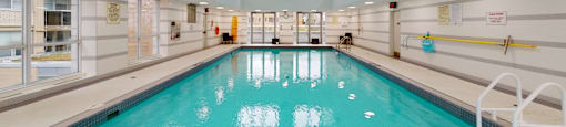 A large indoor swimming pool with a blue tiled bottom at Vivere.