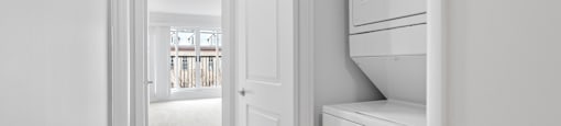 A white kitchen with a refrigerator and oven.