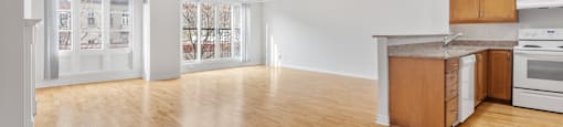 A kitchen with wooden floors and white walls.